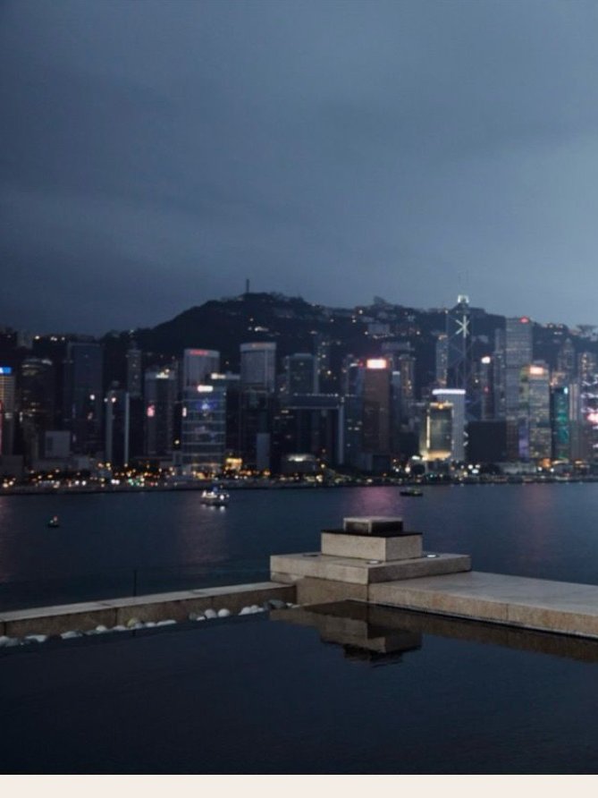 The Hong Kong Island skyline across Victoria Harbour at dusk