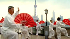 Tai chi practitioners with red fans on the Bund — Cisco Human Network