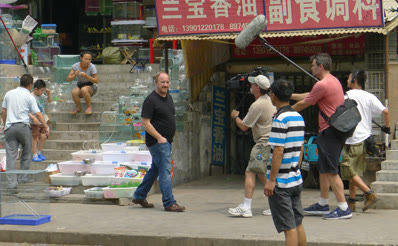 Louis CK filming on a Beijing street with the crew